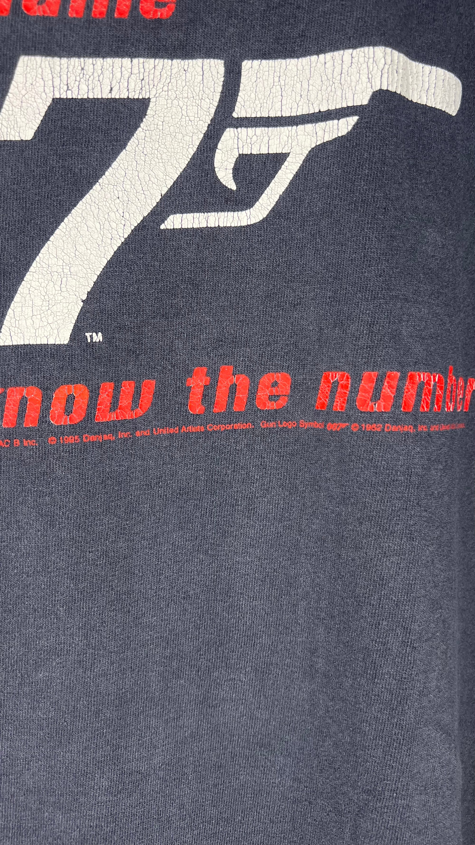 GOLDENEYE MOVIE PROMO MULLET TEE | “YOU KNOW THE NAME, YOU KNOW THE NUMBER” BACK HIT